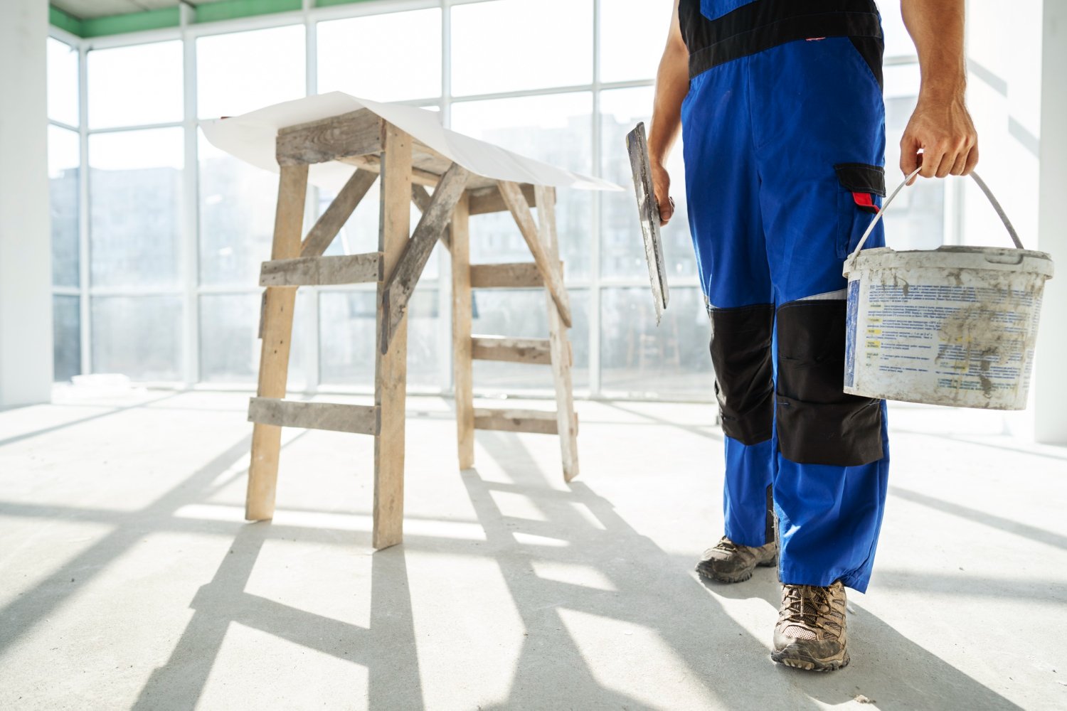 drywaller with compound and trowel - Why Restoration Companies should not self-test for Asbestos