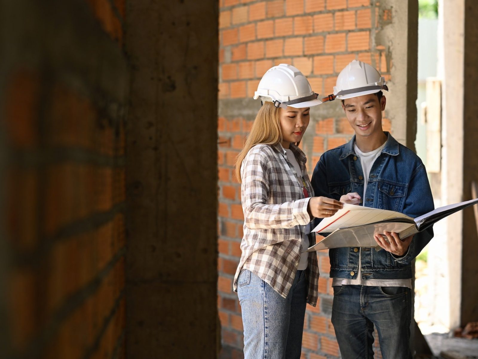 Specialists inspecting commercial building Construction site with civil engineer.